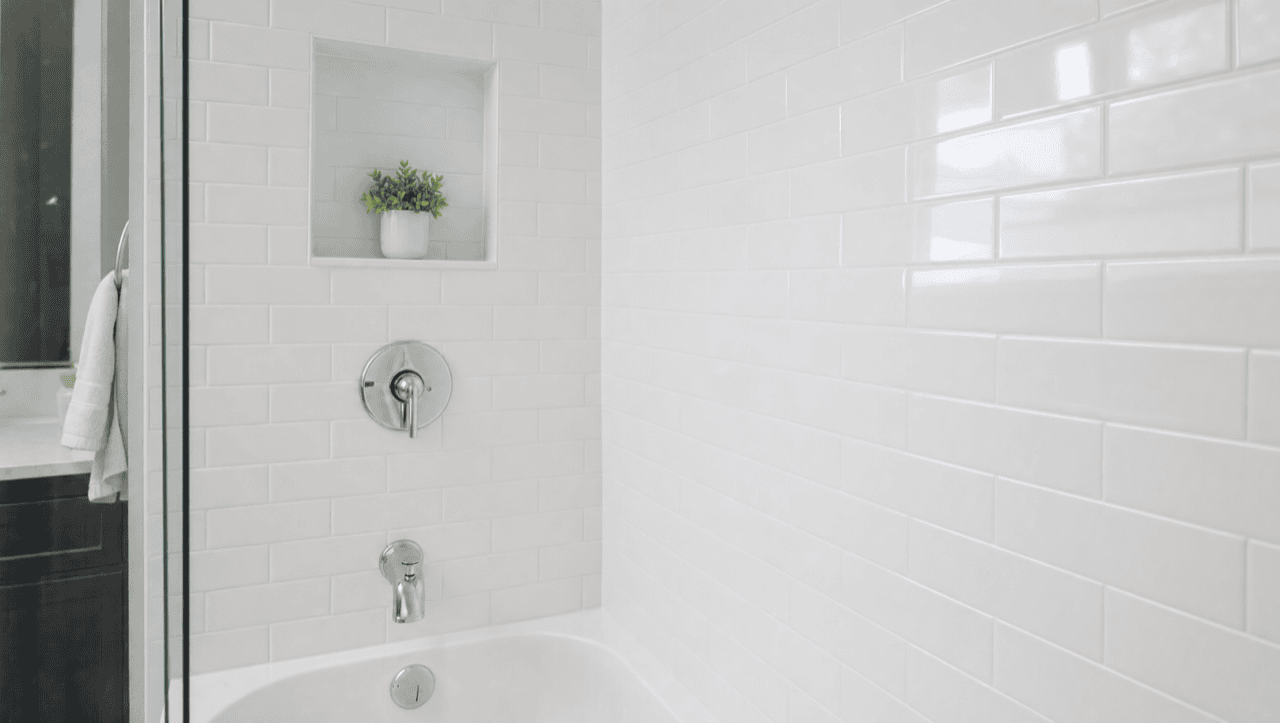 Same shower after tile reglazing — clean sealed white